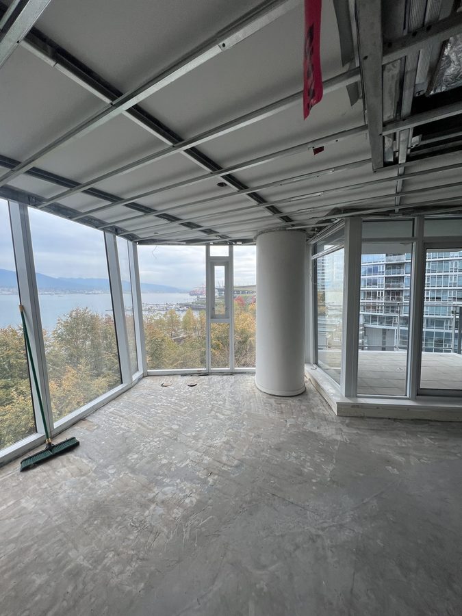 Steel ceiling framing in a corner high-rise suite with floor-to-ceiling glass