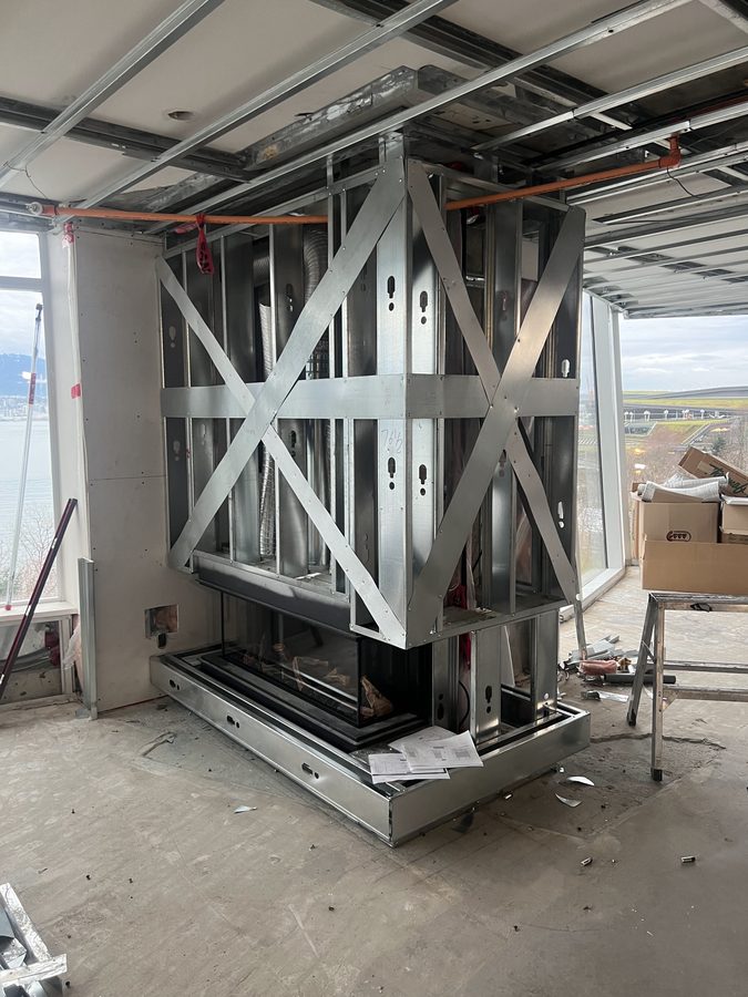 Braced steel stud framing around a linear gas fireplace in a high-rise suite