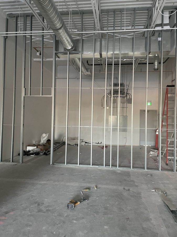 Steel stud partition framing with door openings in an empty commercial space