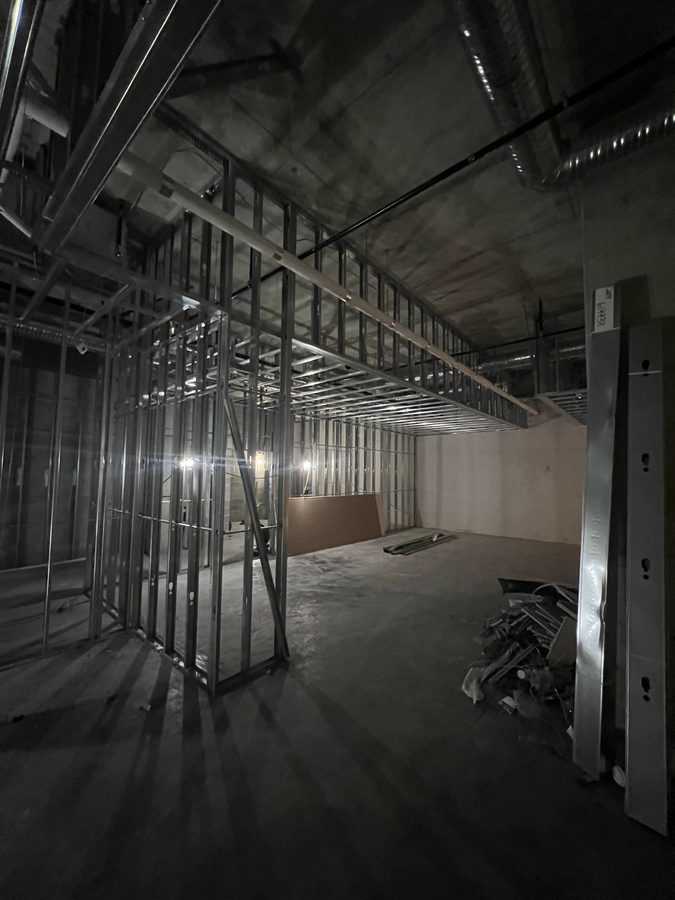 Steel stud partition and ceiling framing inside a concrete shell